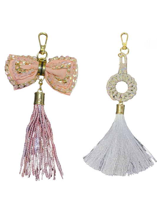 A peach bow bag charm & a white tassel charm that will help you to elevate your style game. 