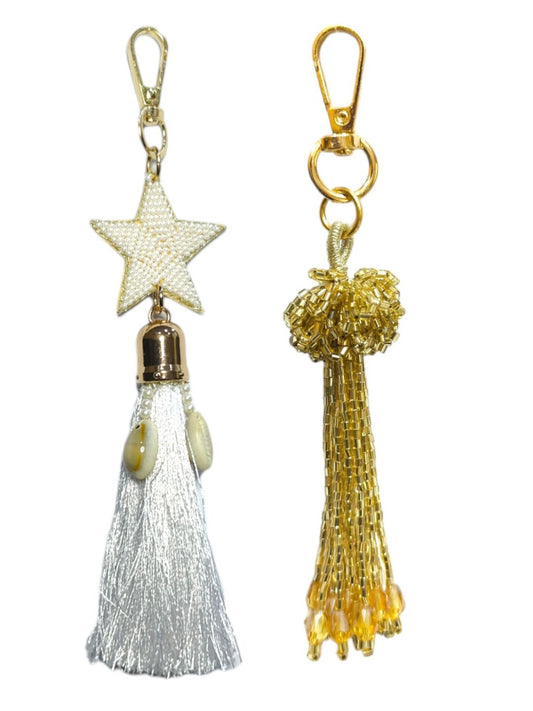 An amazing combo of white star & gold tassel bag charm that will help you to stand out form the crowd. 