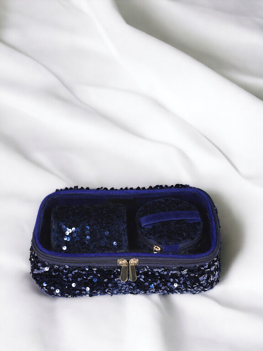 A Vdesi blue sequin accessory organizer on a white bed, perfect for organizing all your make up pouch essentials.