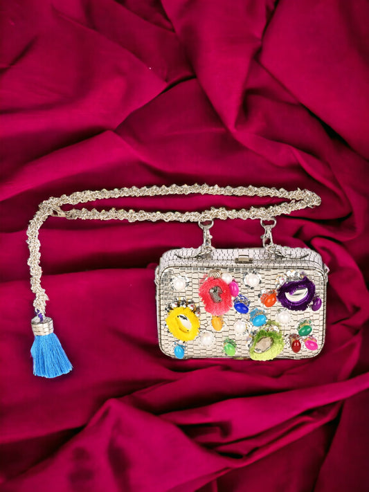 A Rangeela silver waist cum sling clutch purse adorned with colorful beads and tassels from Vdesi.