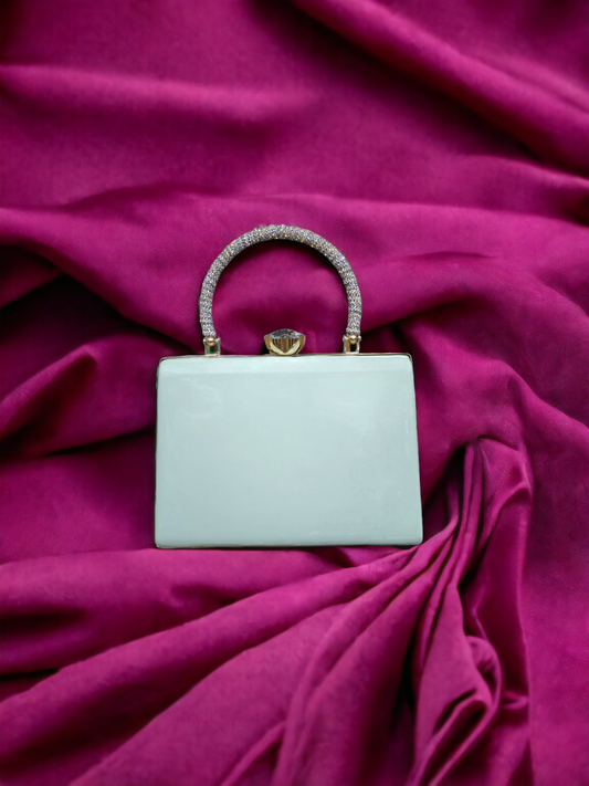 A ladies clutch on a pink background. 