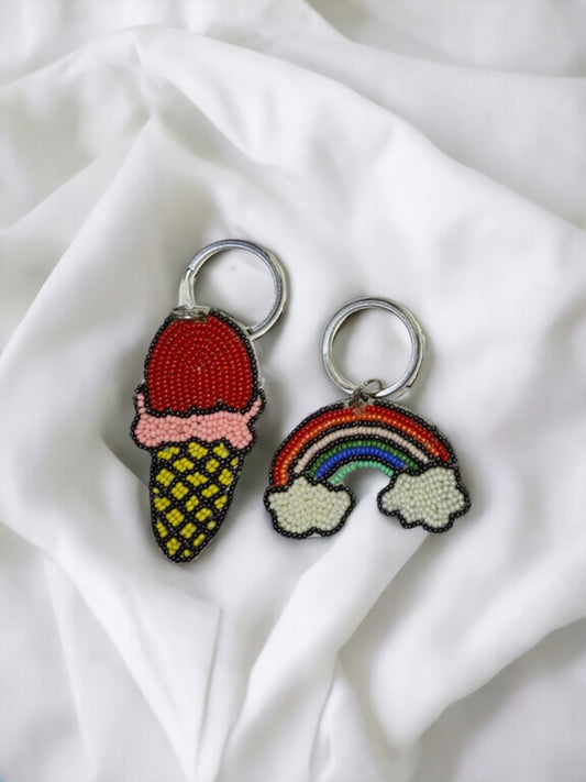 Two Vdesi keychains of Ice-cream & Rainbow on a plain white sheet. 