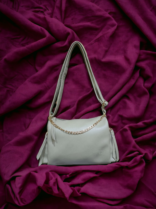 A Vdesi crossbody bag on a plain pink background. 