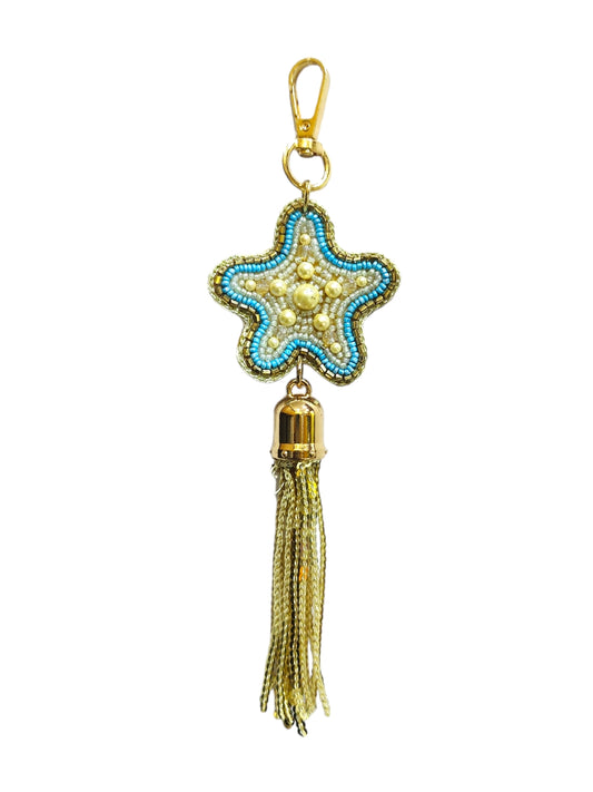 Introducing the enchanting Blue Star Bag Charm, a delightful accessory designed to add a touch of celestial elegance to your favorite handbag or backpack.