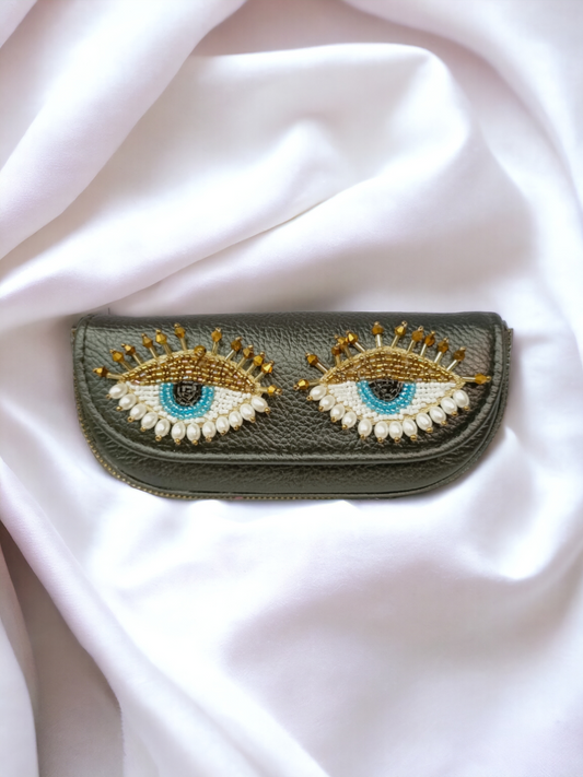 A ladies sunglass case with pretty eyes on it. 