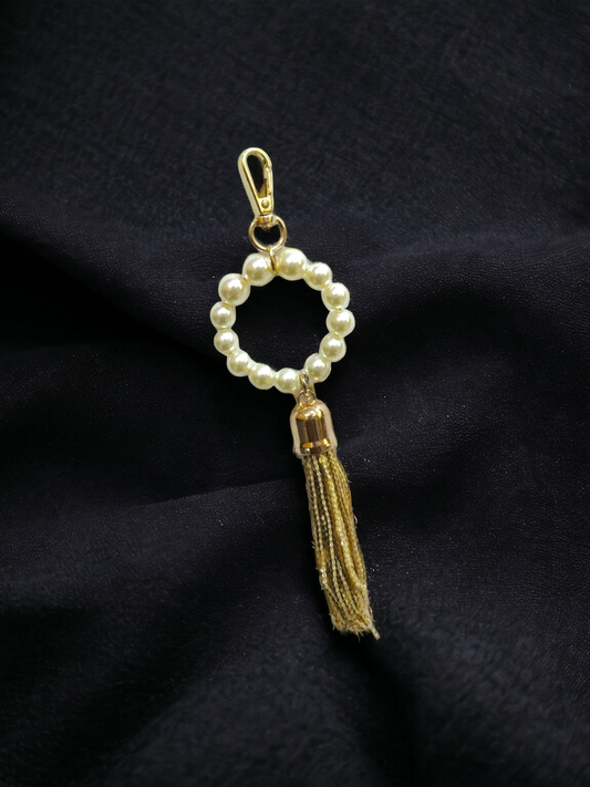 A Vdesi pearl tassel charm which will elevate your look. 