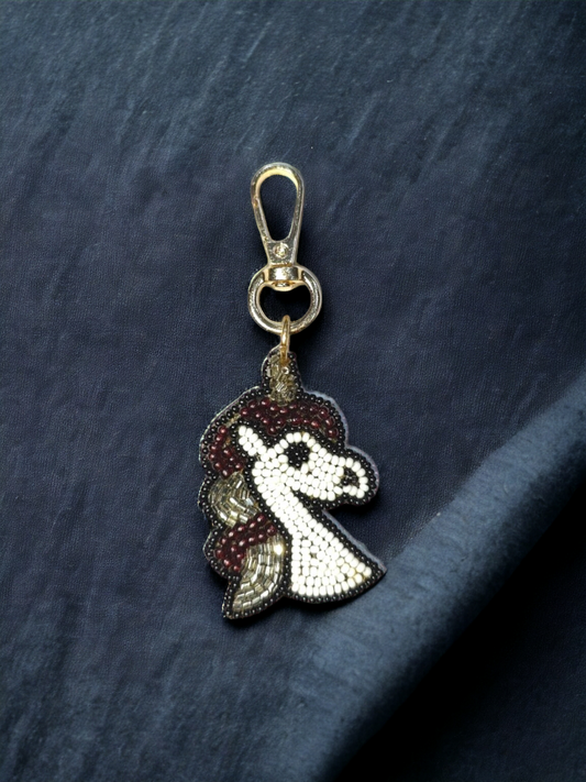 Transform your bag into a realm of enchantment with our White Unicorn Bag Charm. 