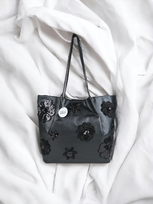 A Vdesi black floral tote bag with embroidered motifs.