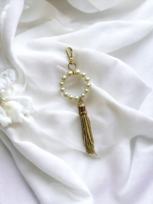 Whether you're accessorizing for a special occasion or simply adding a chic accent to your everyday look, this pearl tassel charm is sure to garner admiration and elevate your style.