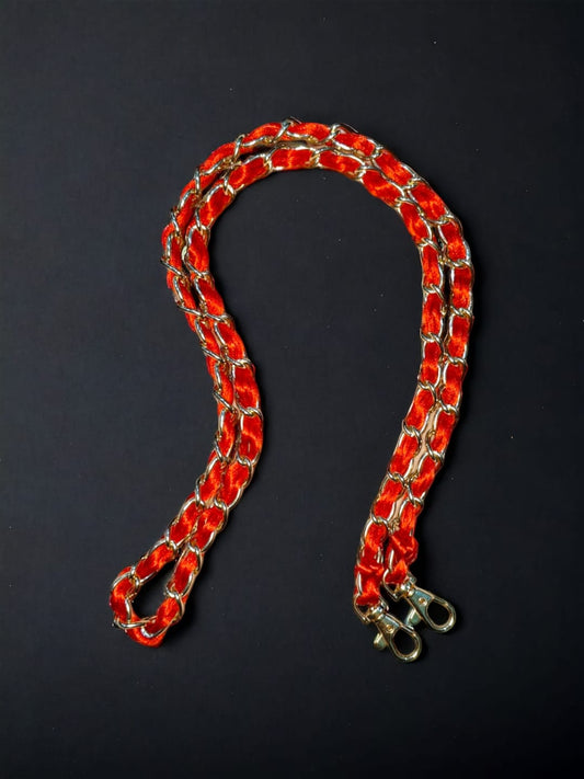 A Vdesi red belt which can be attached to a purse, clutch, bag or a sling bag. 